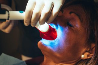 Caucasian Patient Goes To Dentist's Office For Teeth Whitening